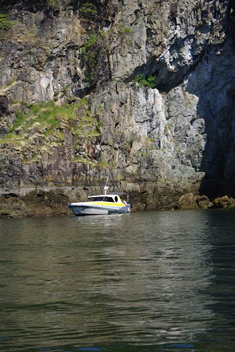 tour boat in front of shear rock walls, Agamemnon Channel