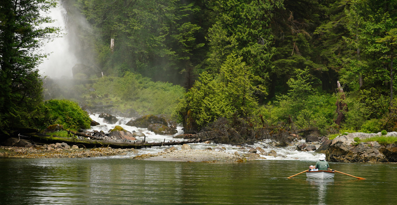 A row boat in front of Chatterbox Falls in Princess Louisa Inlet.