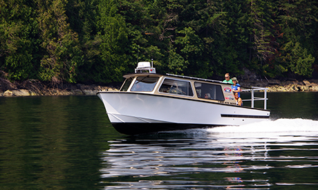 RedLine, 12 passenger tour boat with passengers outside on back deck